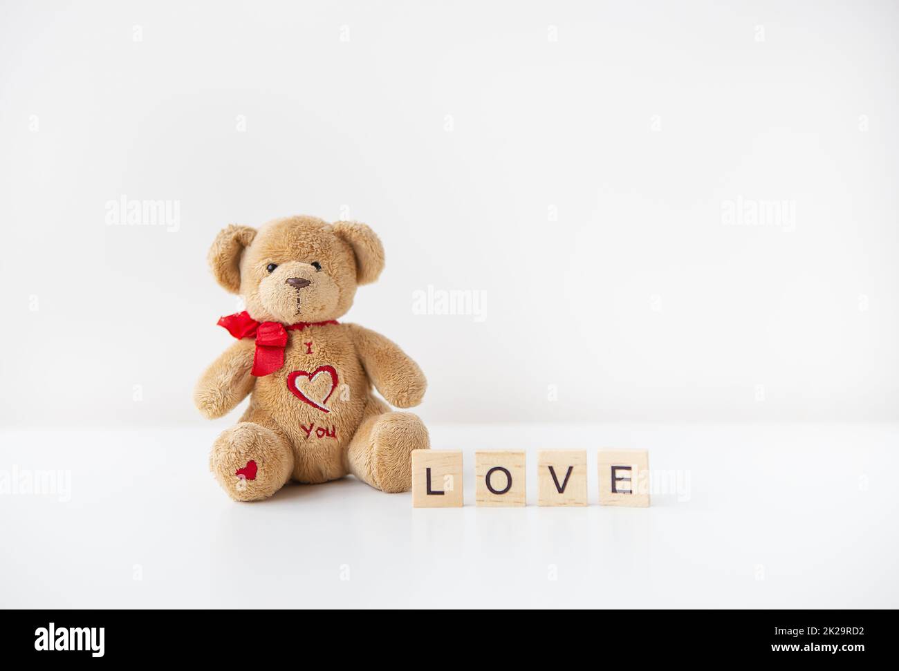 Cute toy teddy bear with a heart isolated on a white background. Love ...