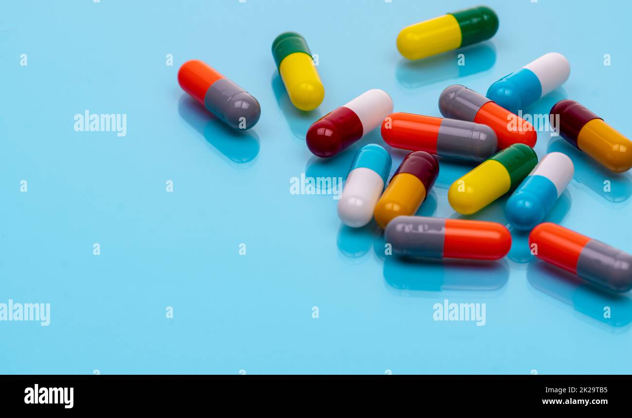 Antibiotic capsule pills on blue background. Prescription drugs
