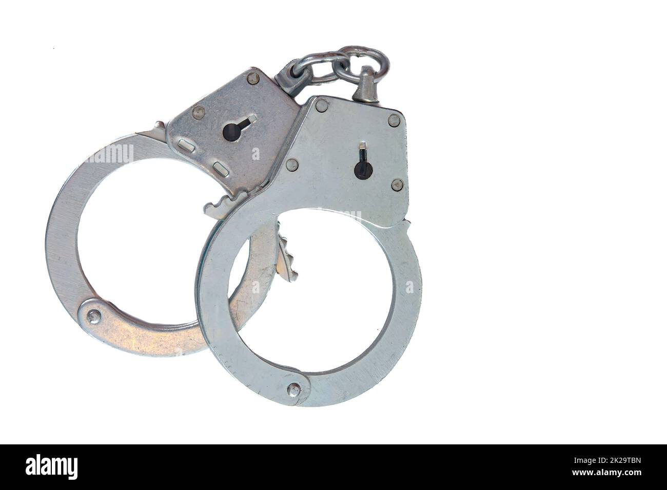 Metal handcuffs on a white isolated background Stock Photo - Alamy