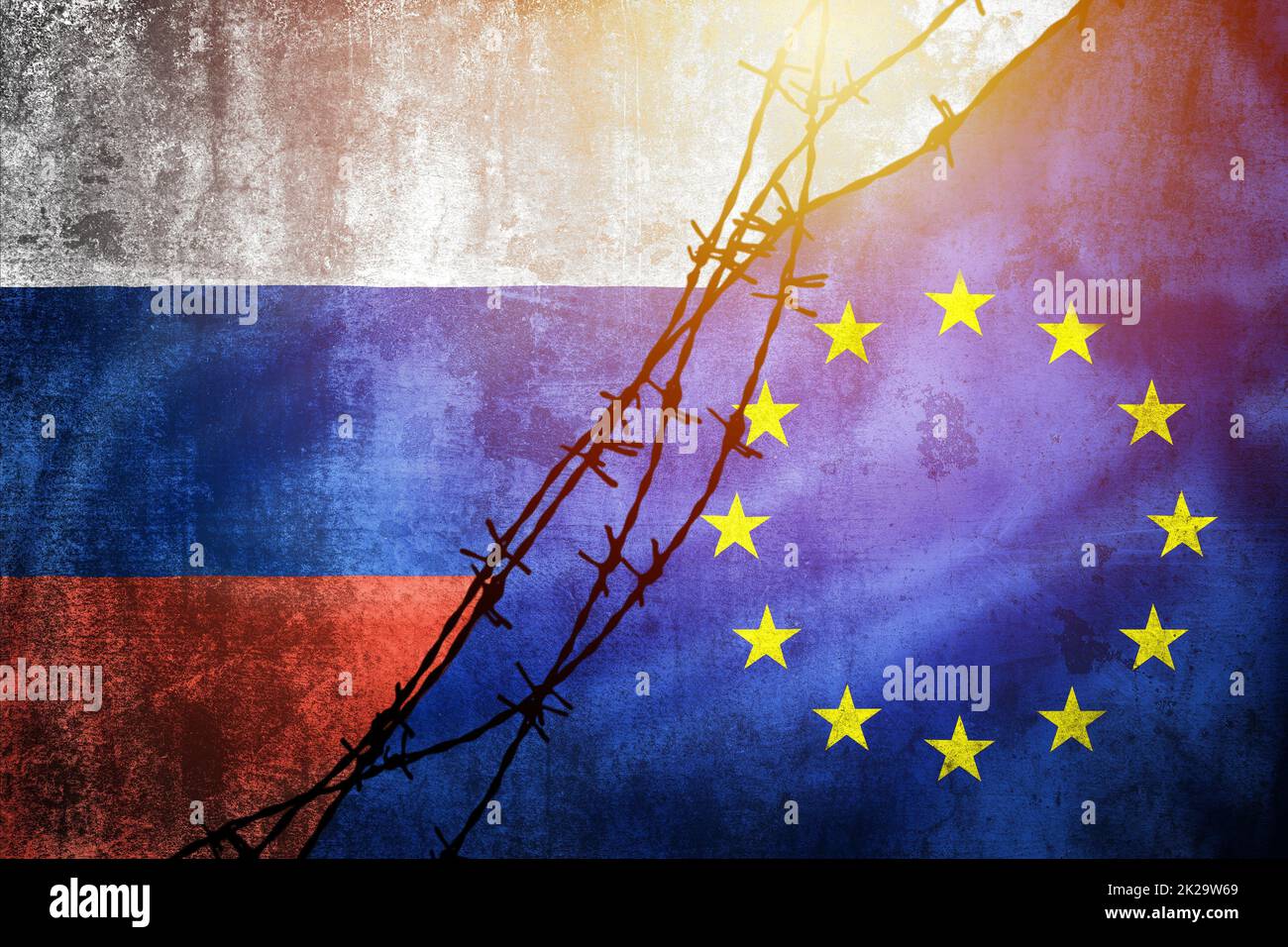 Grunge flags of Russia and European Union divided by barb wire sun haze illustration Stock Photo
