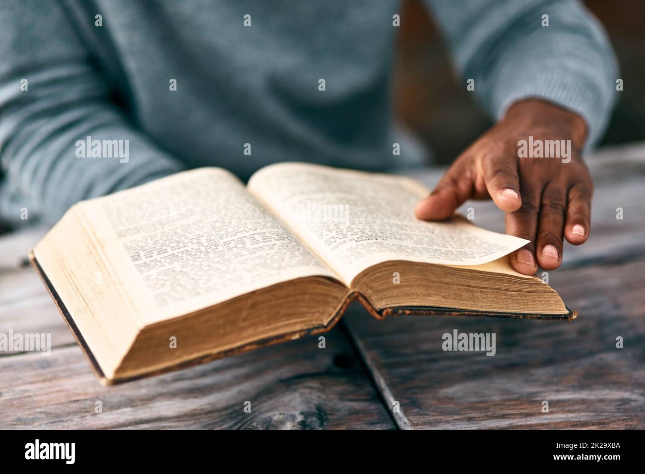 I just have to go back to the previous page. Cropped shot of an unrecognizable man reading a book. Stock Photo