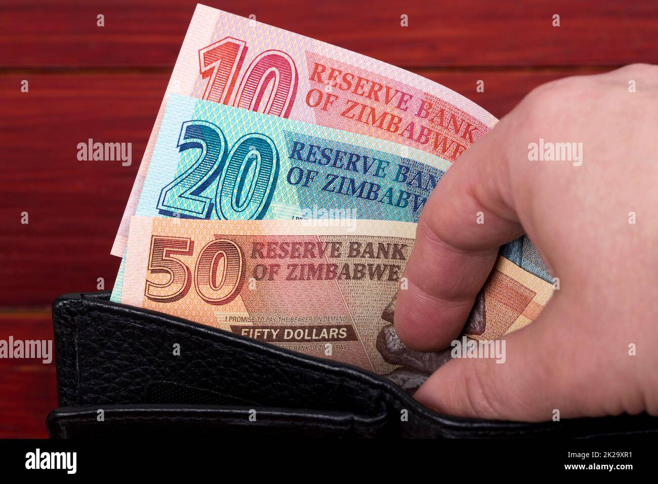 Zimbabwean banknotes in the black wallet Stock Photo