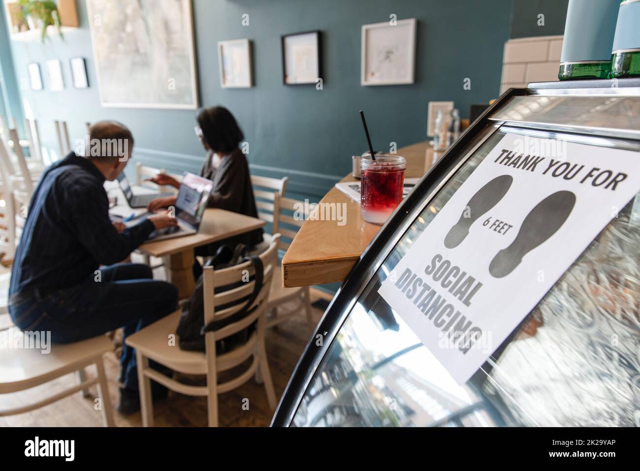 Social distancing sign on cafe counter Stock Photo