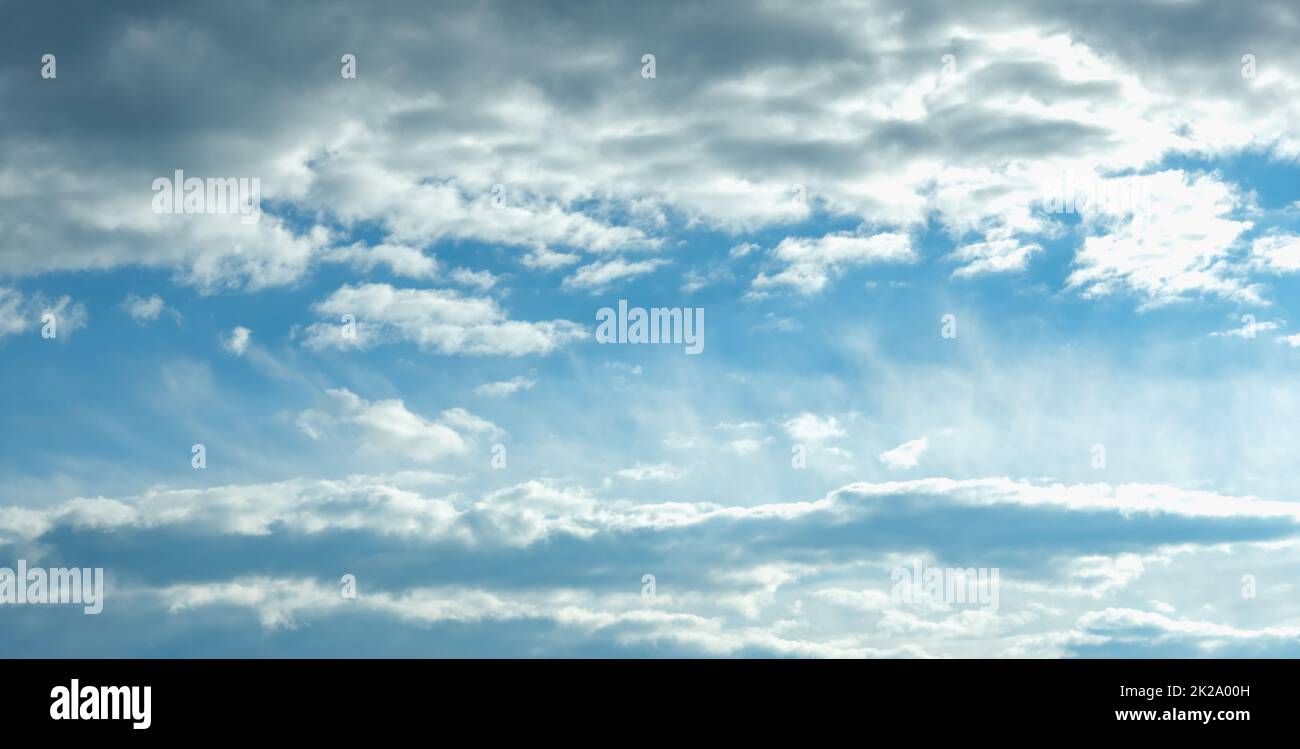 Blue sky with white clouds. Beautiful cloudy sky. Skyward. Endless skyline. The sky at dawn. Banner. Stock Photo