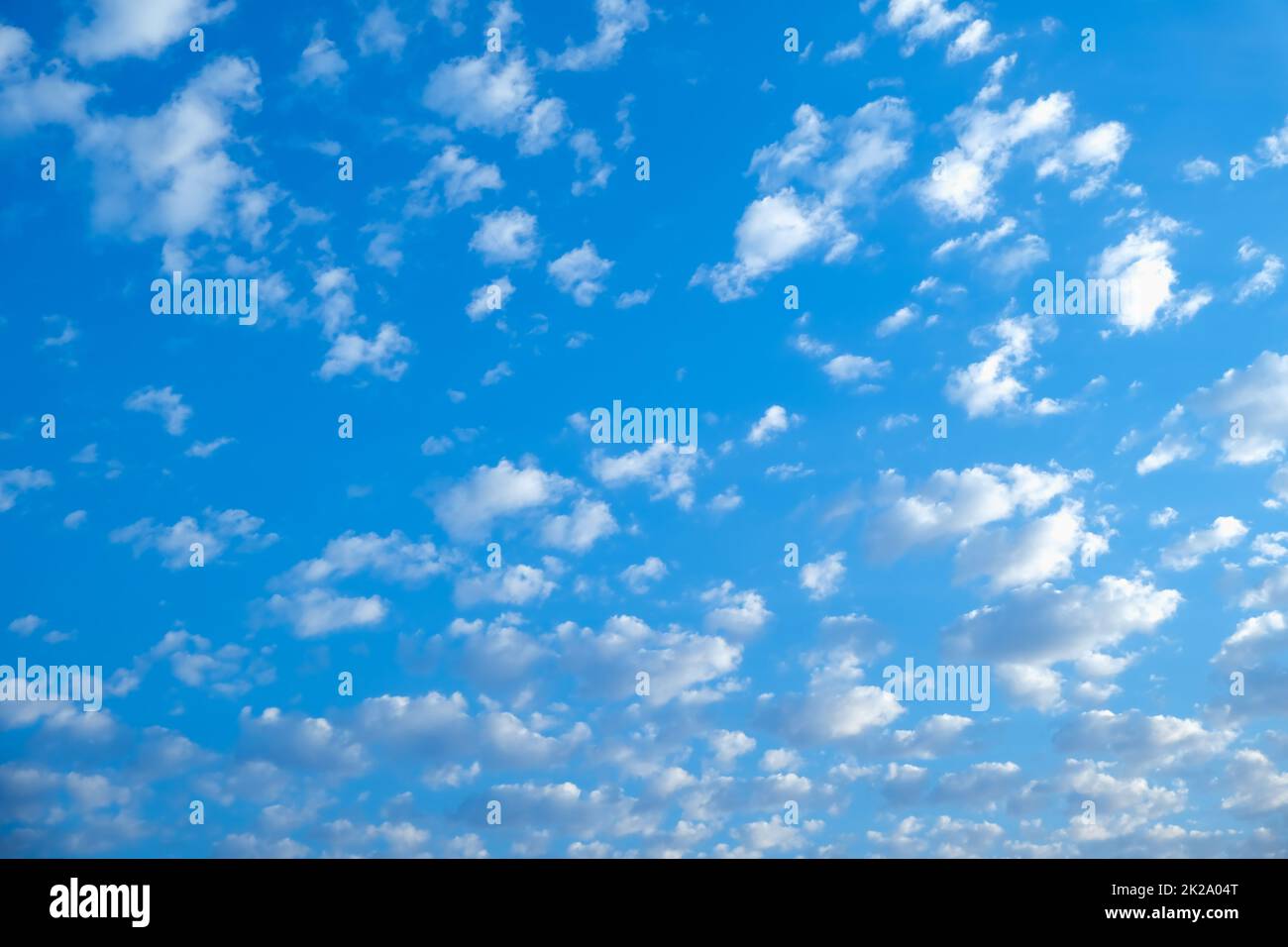 Blue sky with white clouds. Beautiful cloudy sky. Skyward. Endless skyline. The sky at dawn. Stock Photo