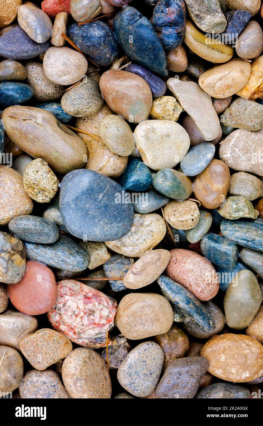 Smooth river rocks are used in landscaping, May 5, 2017, in Mobile, Alabama. River rocks help soil absorb water, prevent runoff, and prevent erosion. Stock Photo