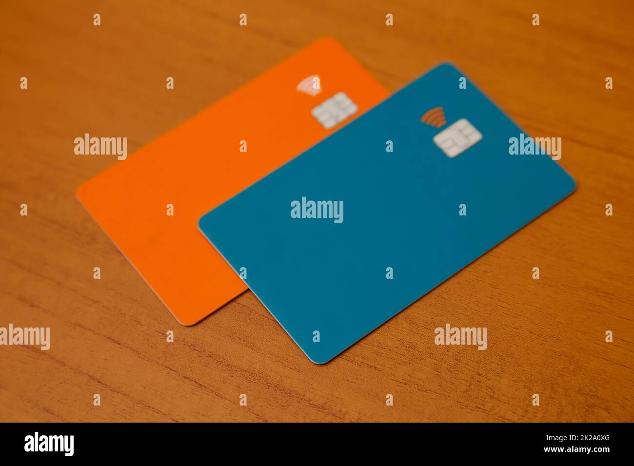 green and orange credit or debit contactless cards with contact less sign. Digital payment system. Selective focus. Stock Photo