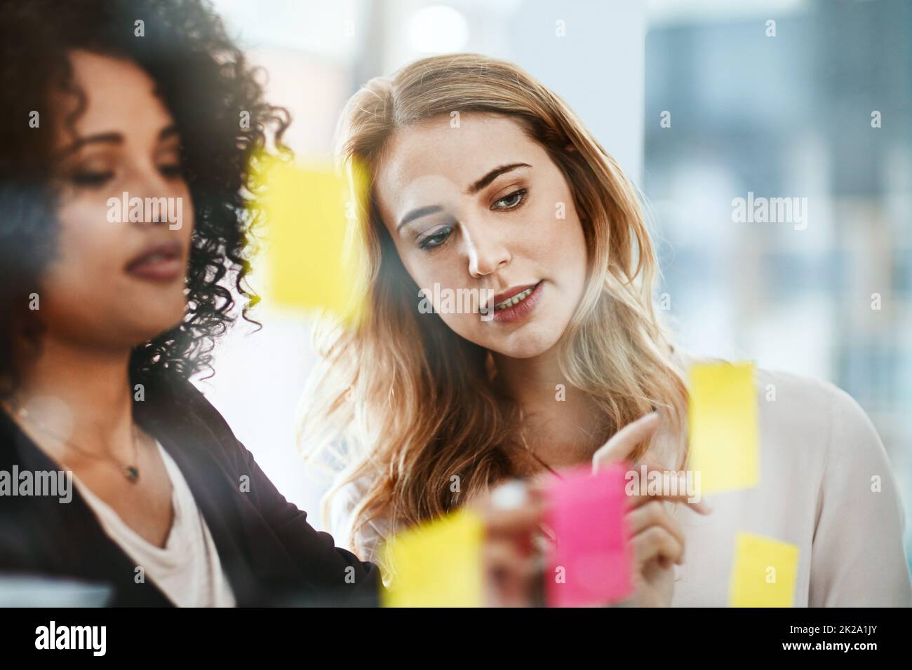 Turning ideas into profit. Shot of two colleagues having a brainstorming session in a modern office. Stock Photo