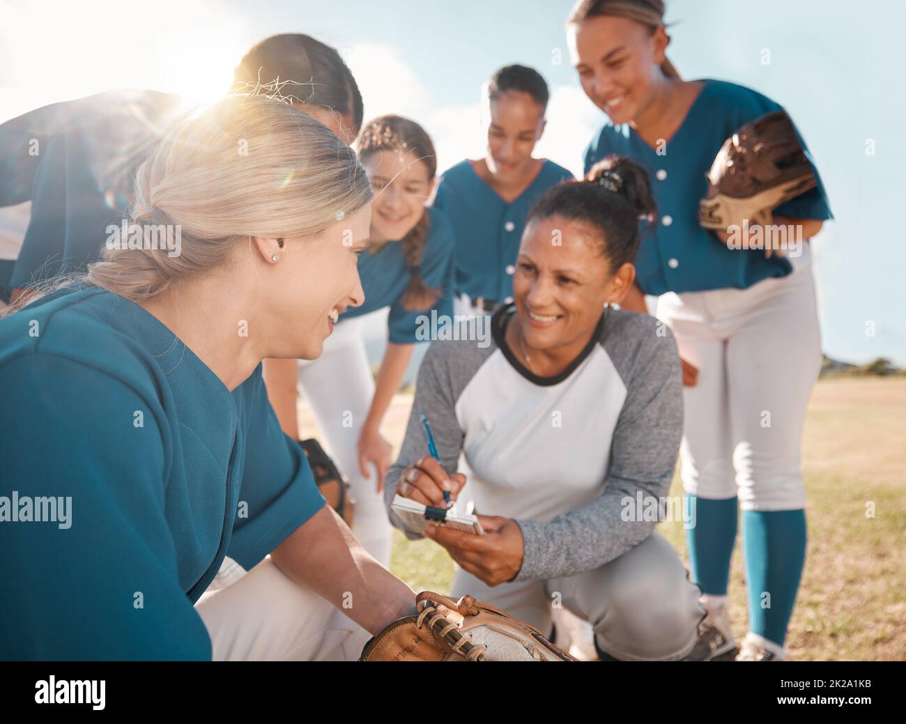 Baseball, sports and coach in team management, collaboration and development during practice on the outdoor pitch. Happy competitive women in sport Stock Photo