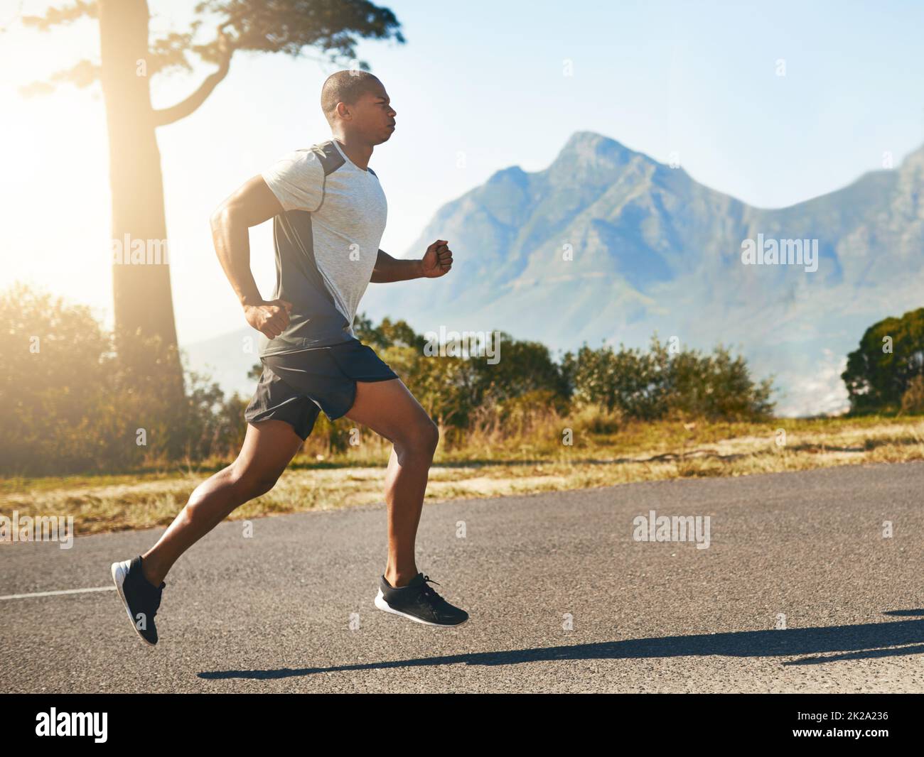 Wind chaser. Shot of a fit young man going for a run outdoors. Stock Photo