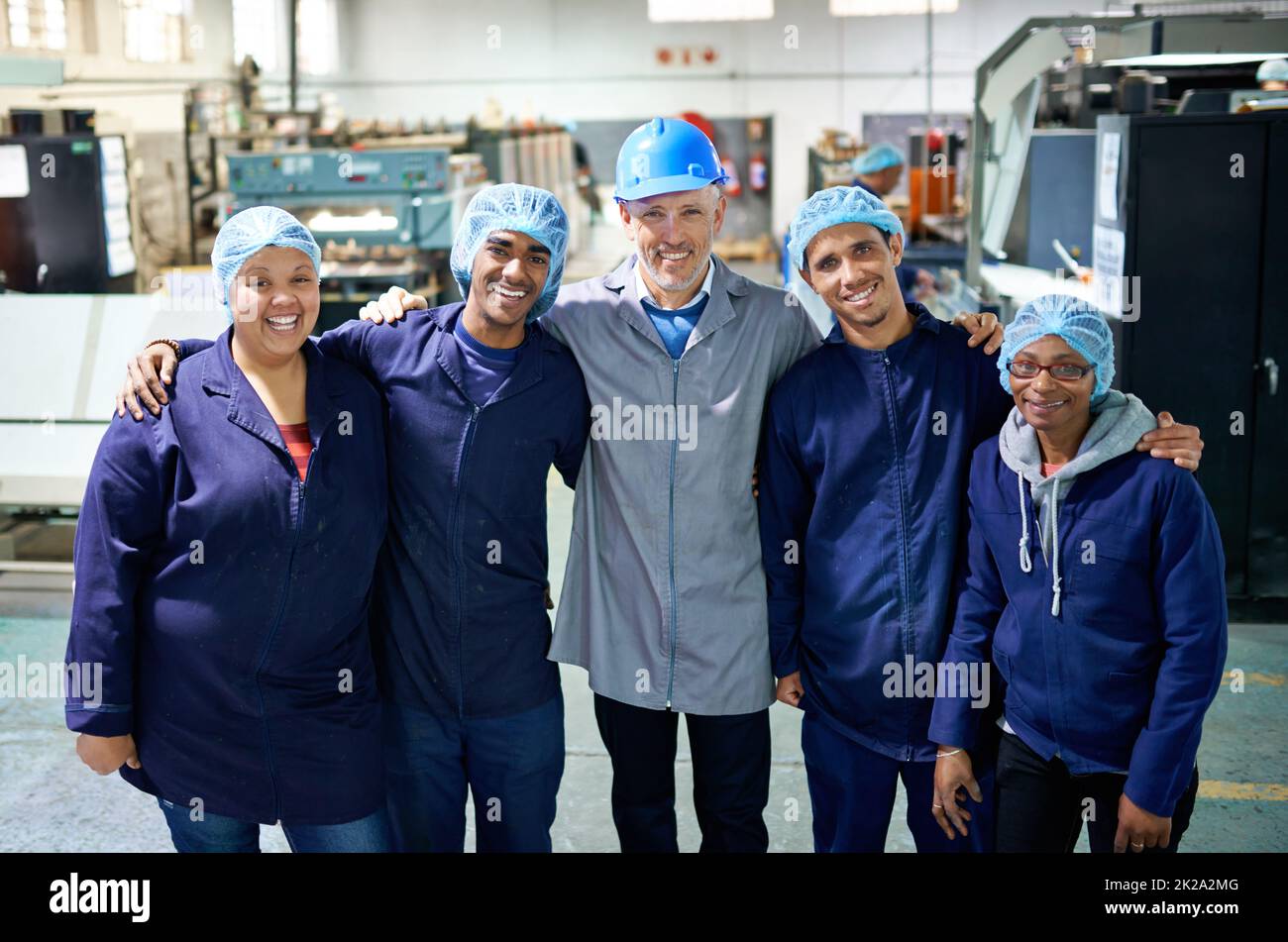 More than employees... Portrait of a people working inside a printing, packaging and distribution factory. Stock Photo
