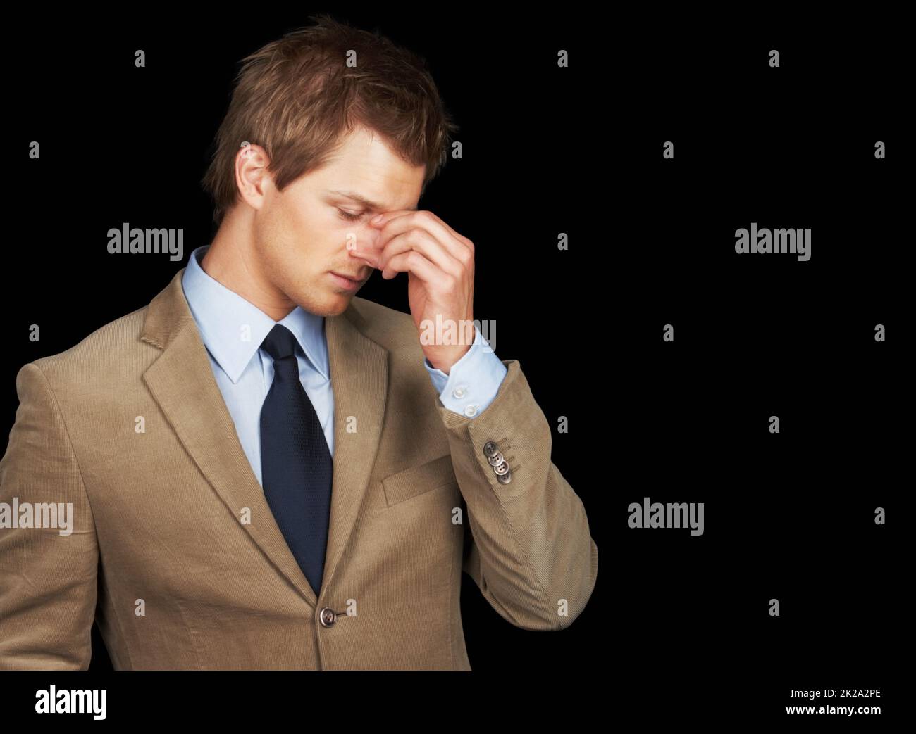 Stressed out business man over black background. Stressed out young business man over black background. Stock Photo