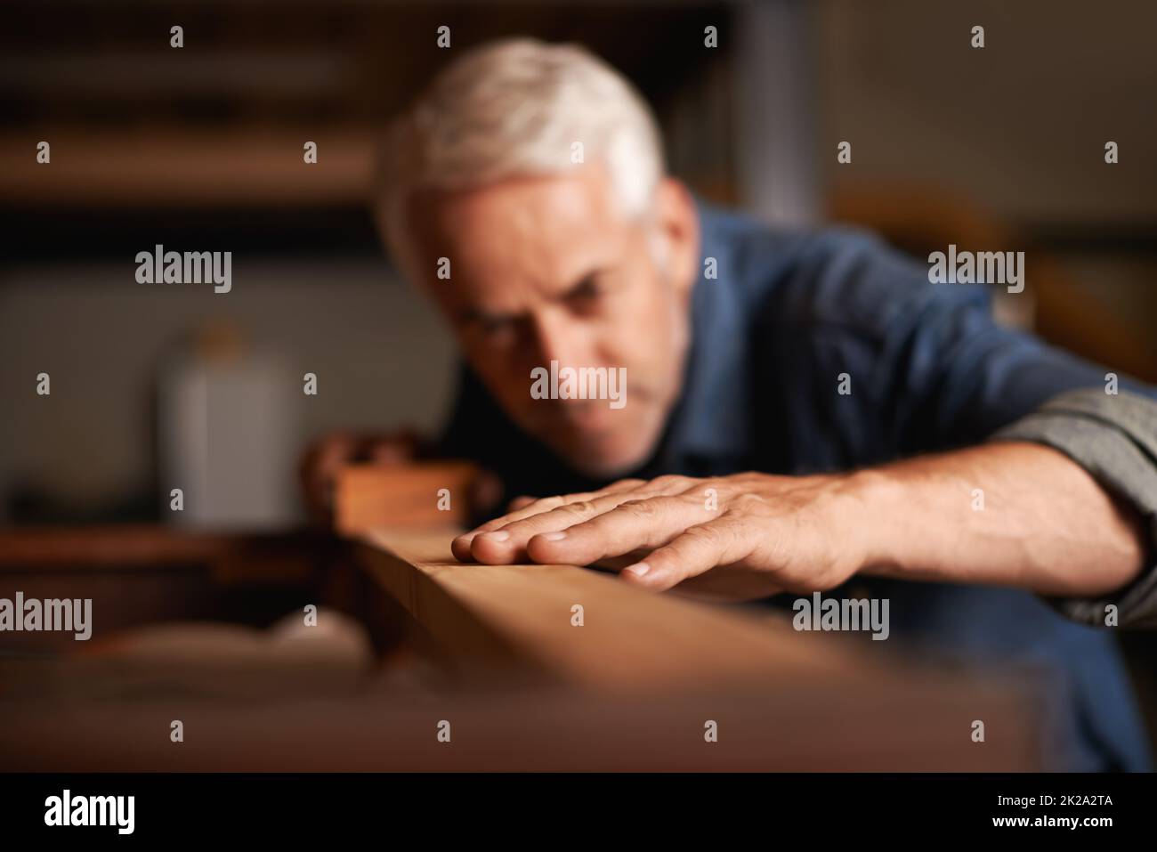 Your dream job does not exist, you must create it. Cropped shot of a senior man working with wood indoors. Stock Photo