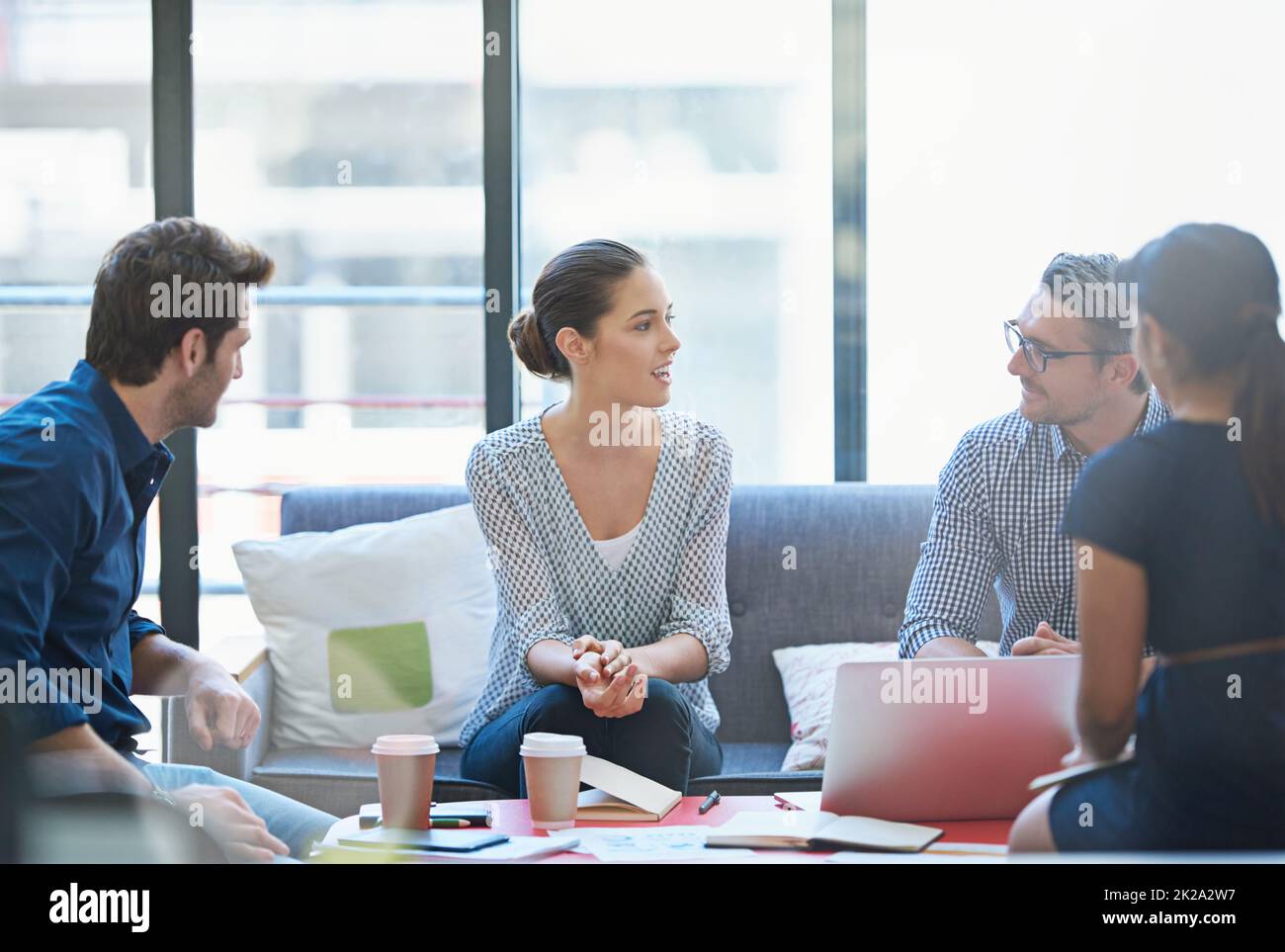 Her Time To Shine Shot Of A Group Of Office Workers Talking Together 