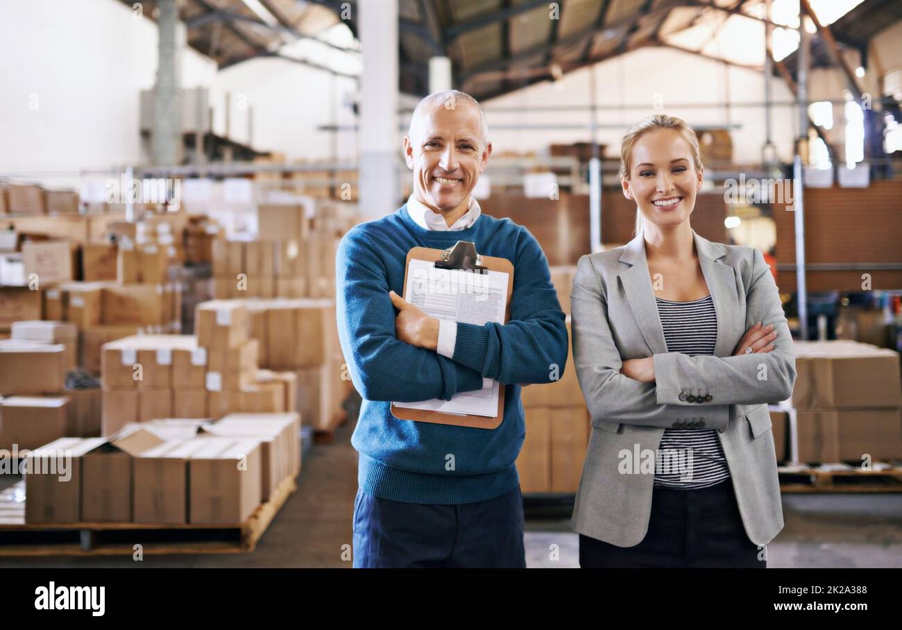 Your shipment is in capable hands. Portrait of two managers standing in a distribution warehouse. Stock Photo