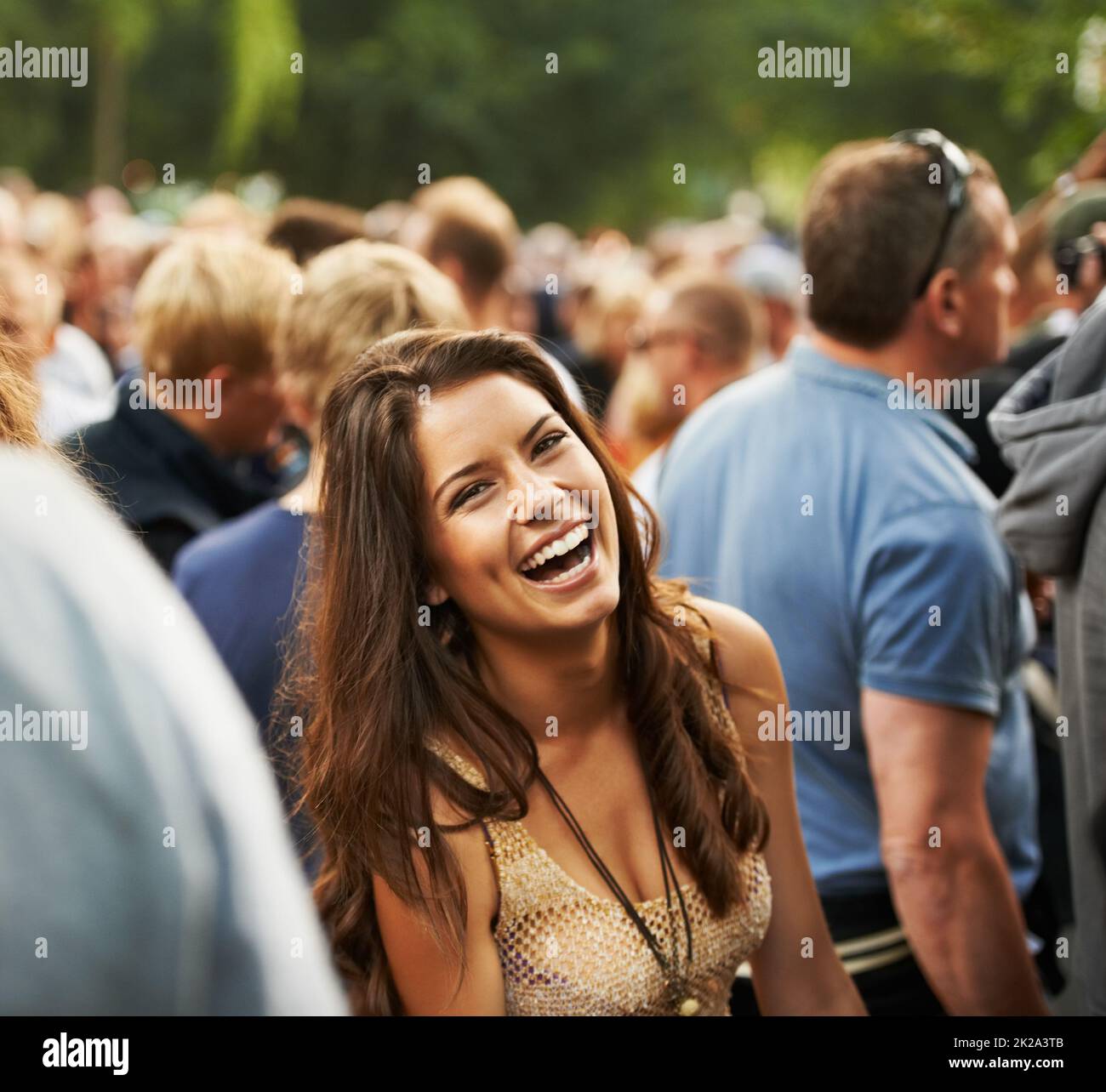 The most fun ever. Portrait of an attractive woman laughing in a crowd at a music festival. Stock Photo