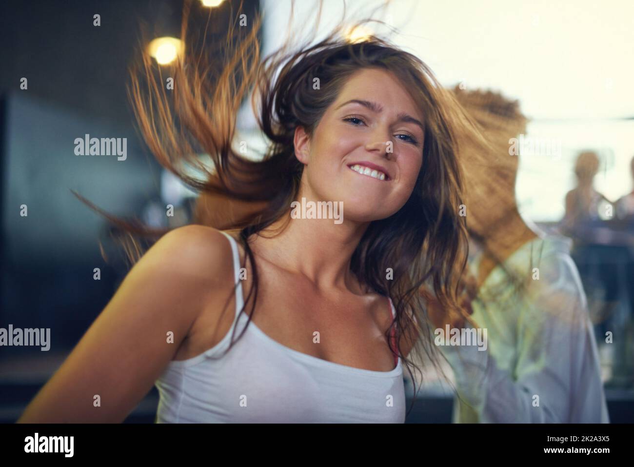 Young woman dancing to the music at a concert. This concert was created for the sole purpose of this photo shoot, featuring 300 models and 3 live bands. All people in this shoot are model released. Stock Photo