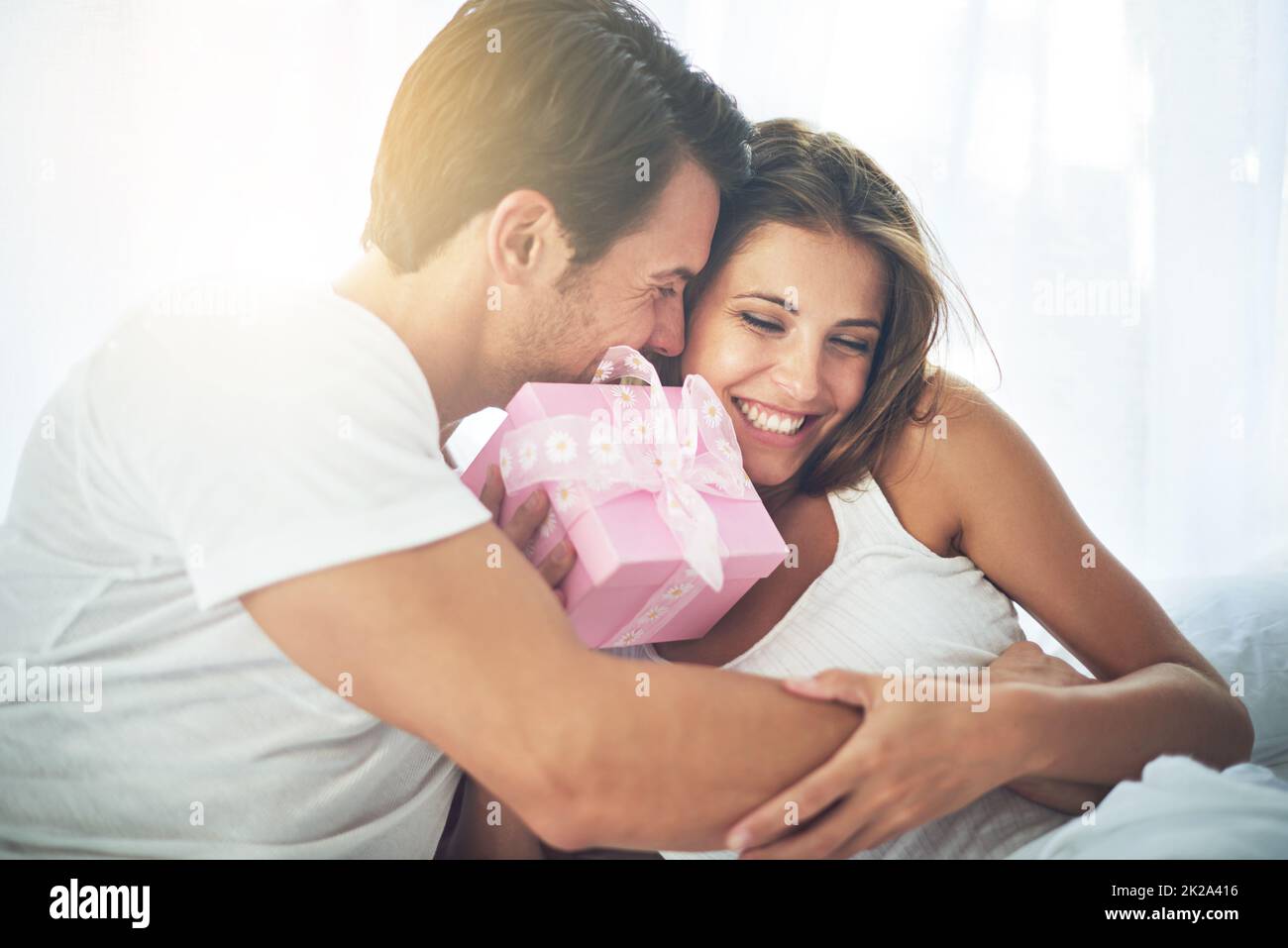 Because youre so special to me. Shot of a loving husband giving his wife a gift. Stock Photo