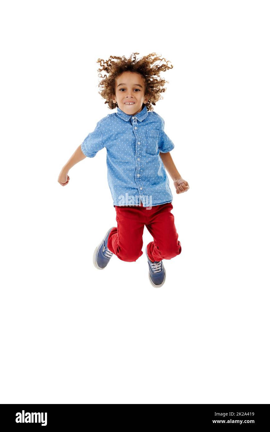 Jumping for joy. Studio shot of a cute little boy jumping for joy against a white background. Stock Photo