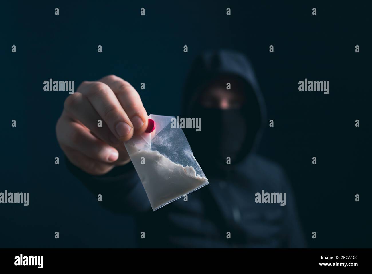Male silhouette holding packet with drug. Trafficking crime, lifestyle. Stock Photo