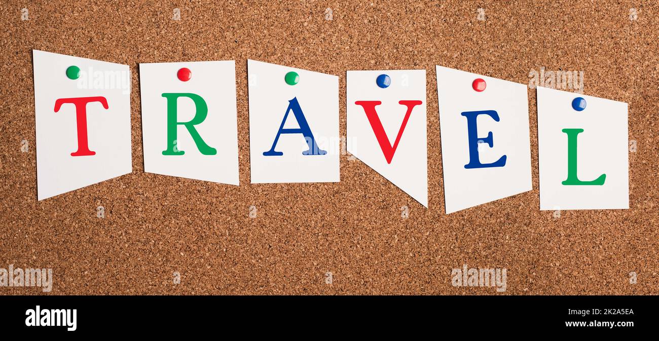 The word travel is standing on pinned paper, vacation in summertime, making an adventure trip, visiting countries Stock Photo