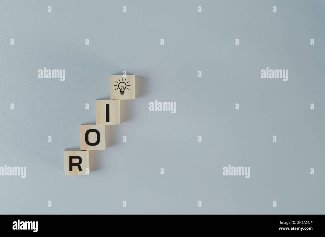 Wooden cubes with ROI Return on Investment symbol on background and copy space.Business concepts. Stock Photo