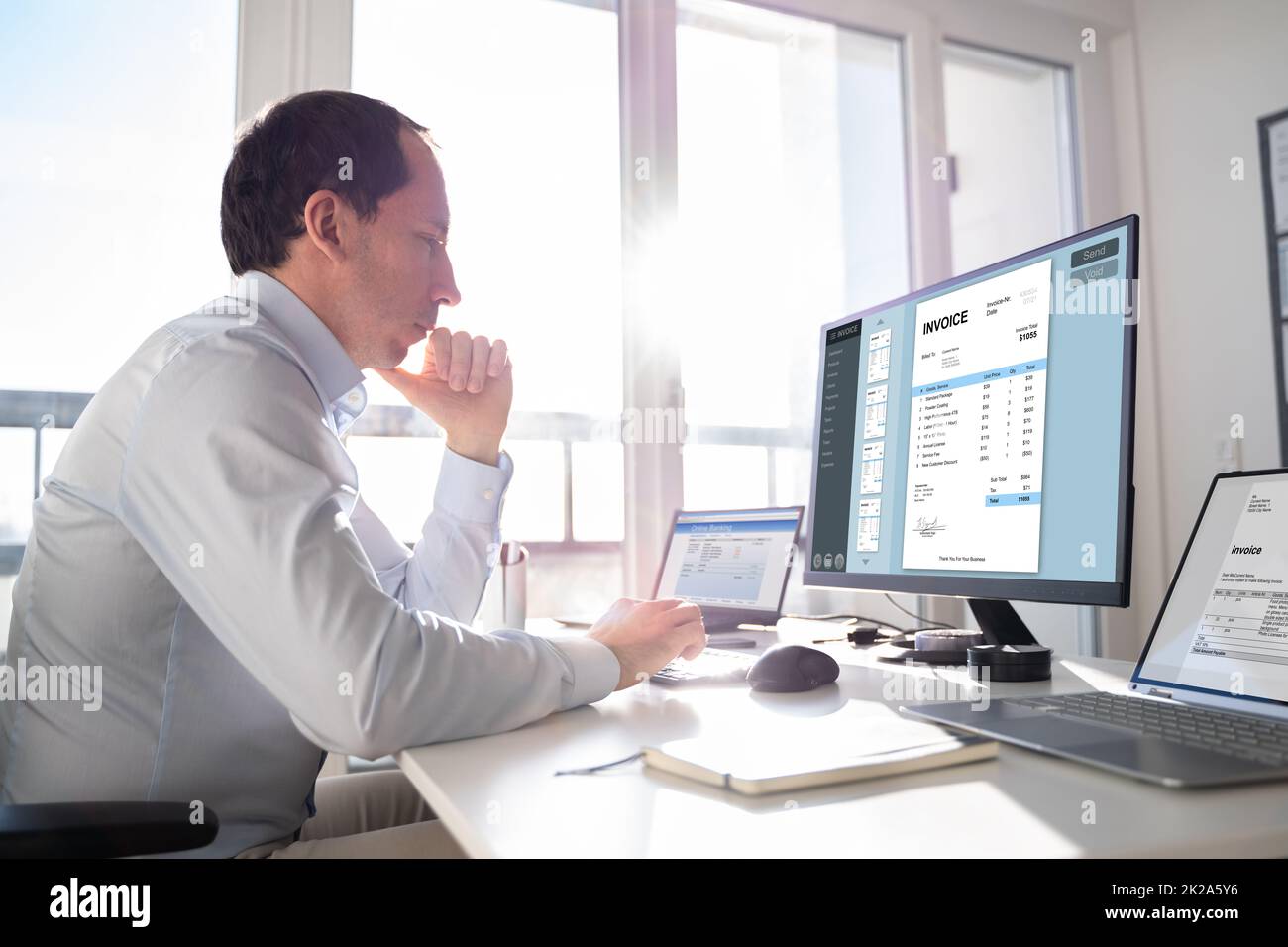 Accountant Using E Invoice Software At Computer Stock Photo