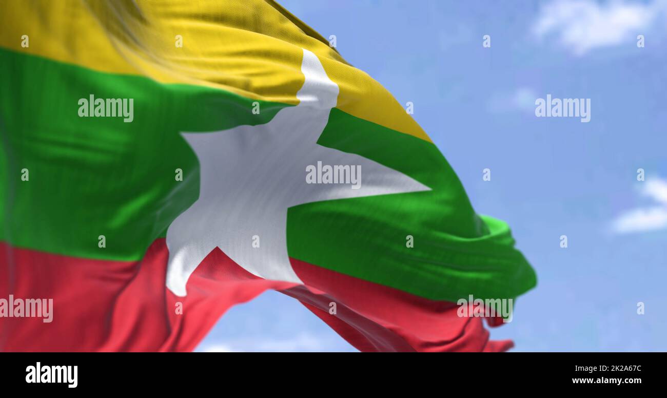 Detail of the national flag of Myanmar waving in the wind on a clear ...