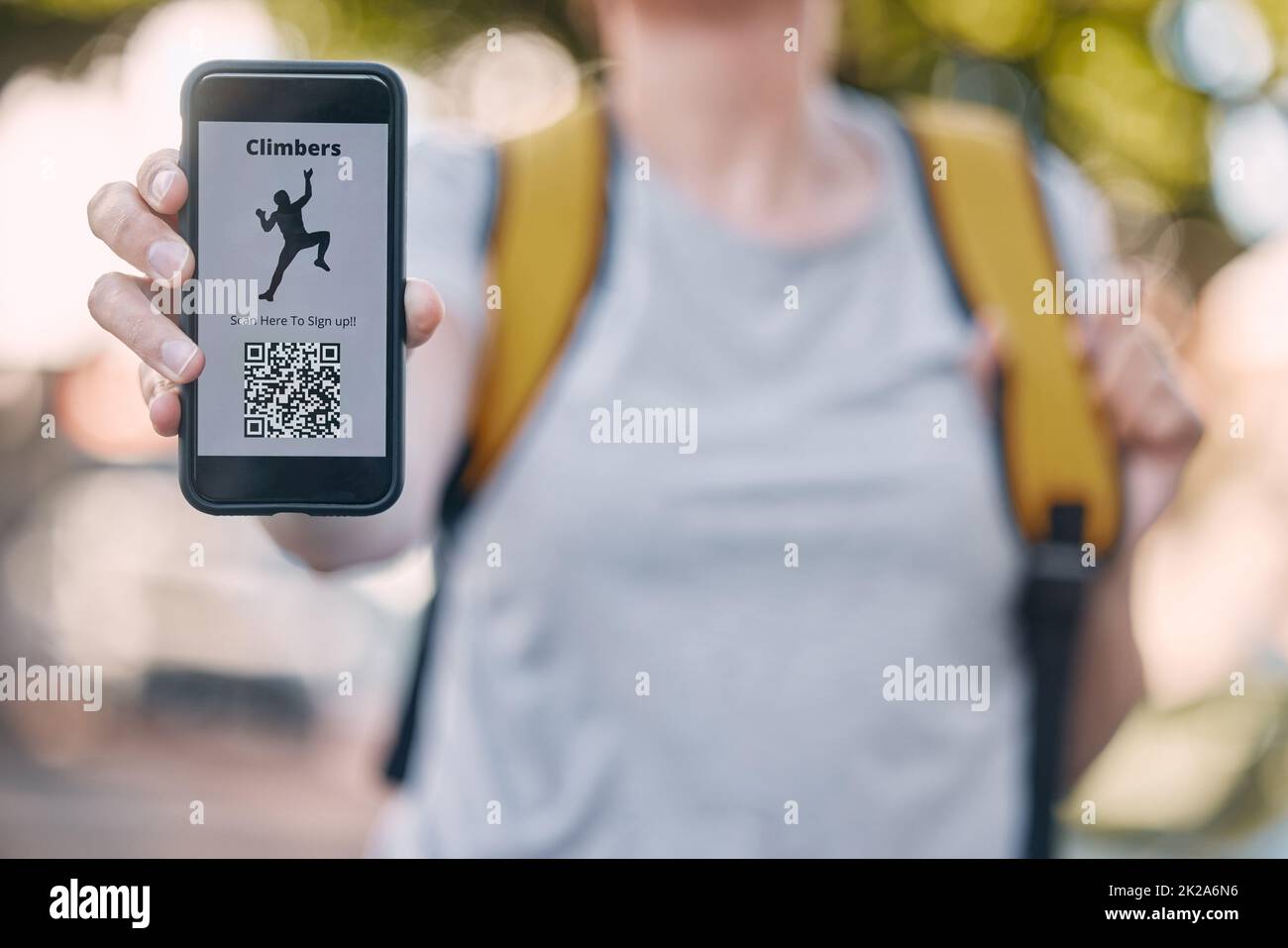 Person with phone and rock climbing app on a qr code scan on screen