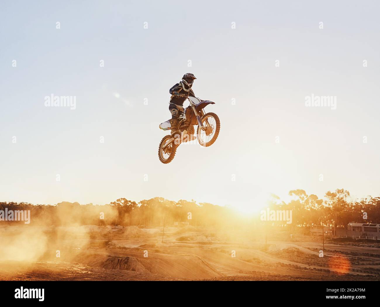 Hes flying through the air. A shot of a motocross rider in midair during a race. Stock Photo