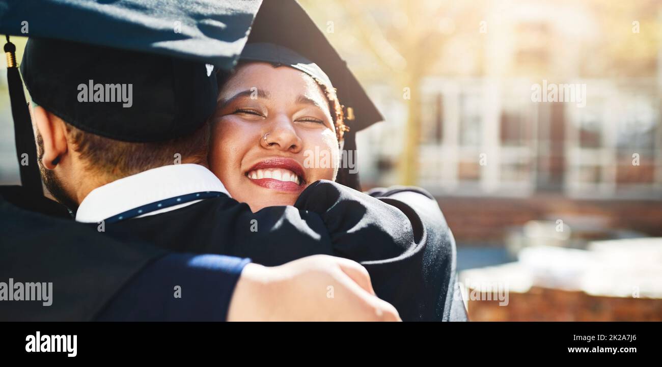 We deserve this just like everyone else. Cropped shot of a young woman embracing her male friend after graduating. Stock Photo
