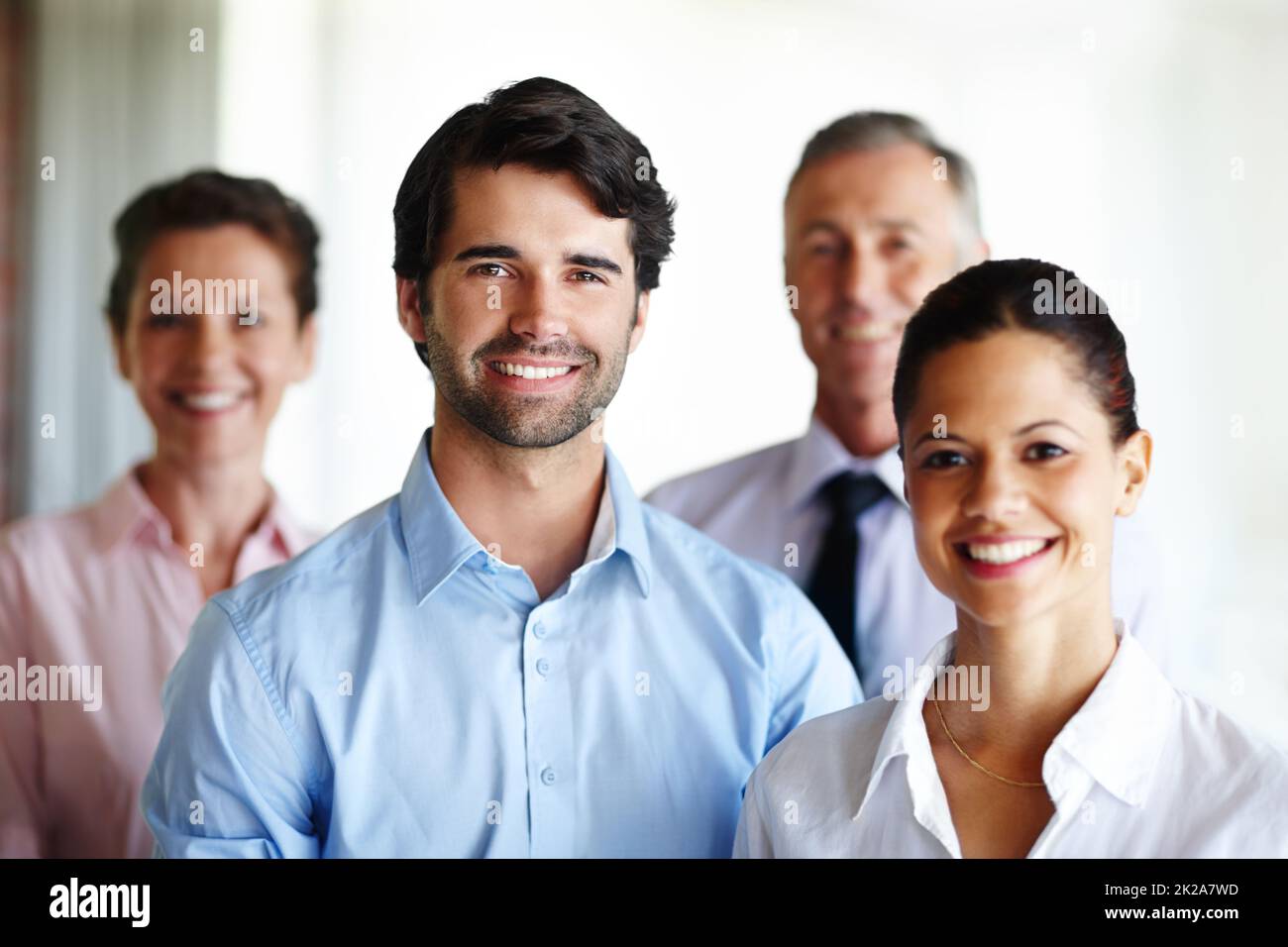 We are a great team. A group of corporate co workers standing alongside each other. Stock Photo