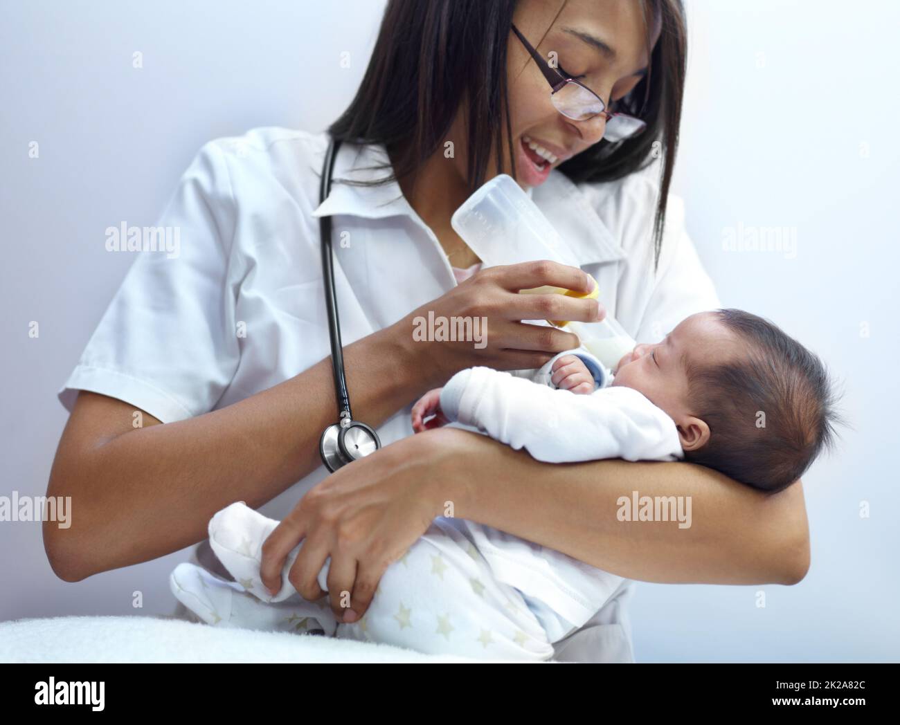 Making a caring contribution to society. Shot of a healthcare worker giving formula to an infant who has a cleft palate. Stock Photo