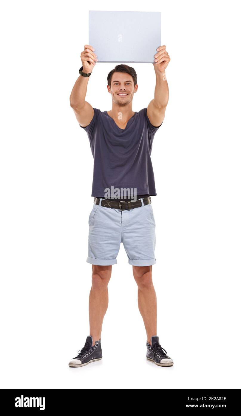 Check this out. Studio portrait of a handsome young man holding up a blank sign isolated on white. Stock Photo