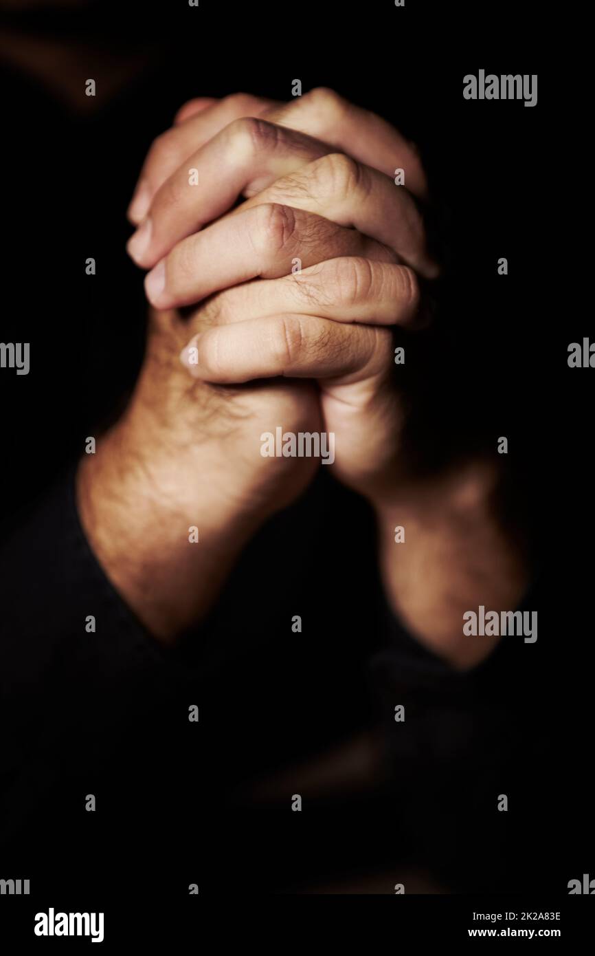 Praying hard for redemption. Hands clasped in prayer. Stock Photo