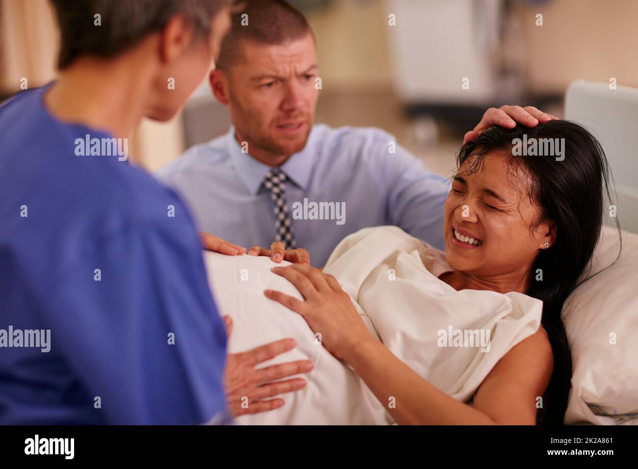 Woman giving birth bed hi-res stock photography and images