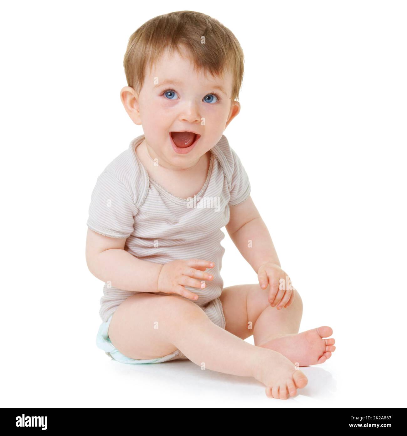Baby laughter. An adorable baby sitting down and laughing isolated on
