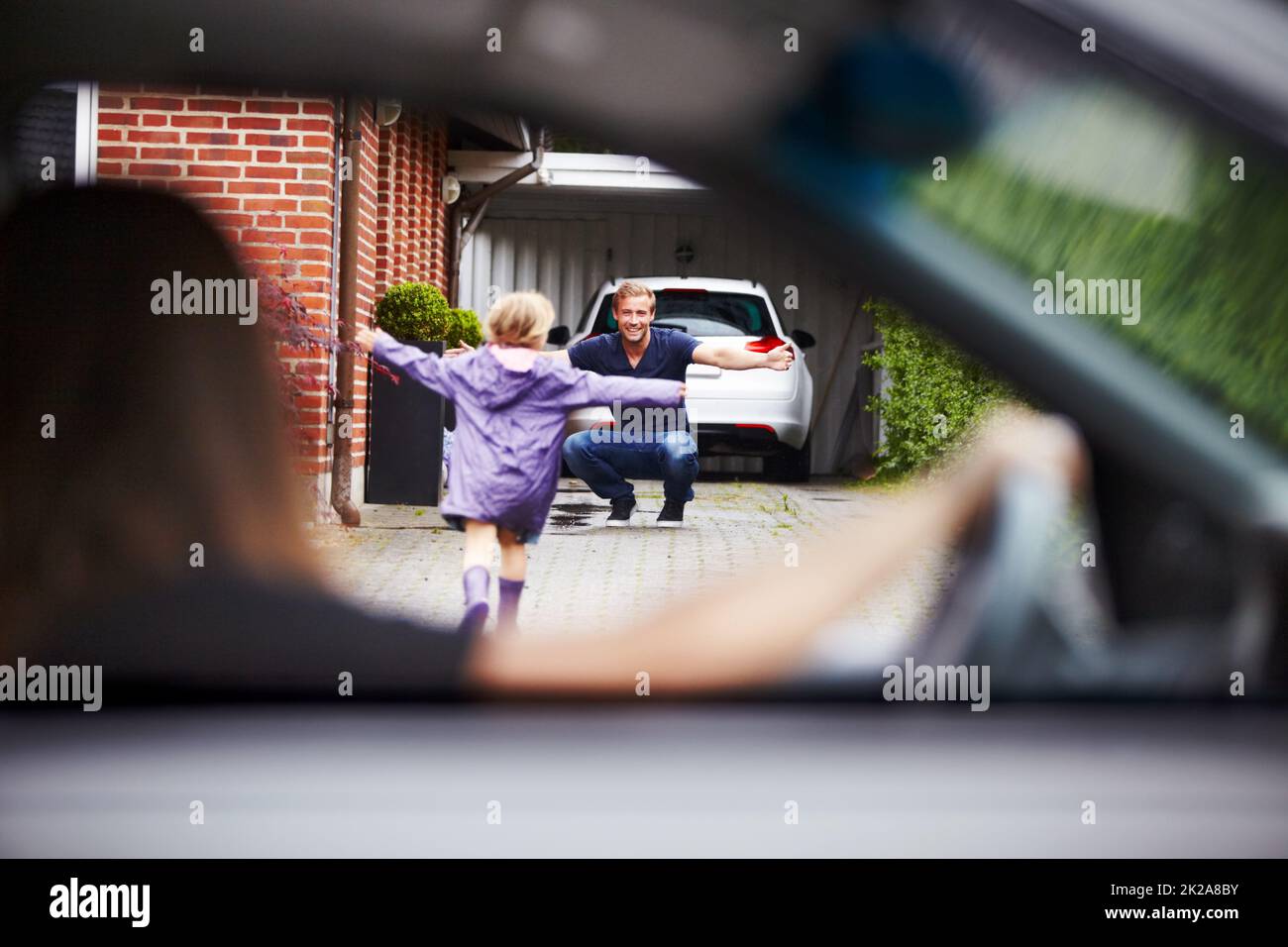 Shes happy to be home. Shot of a little girl running towards her father. Stock Photo