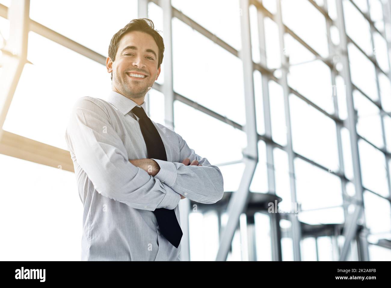 Doing business with the right attitude. Cropped portrait of a businessman standing in the lobby. Stock Photo