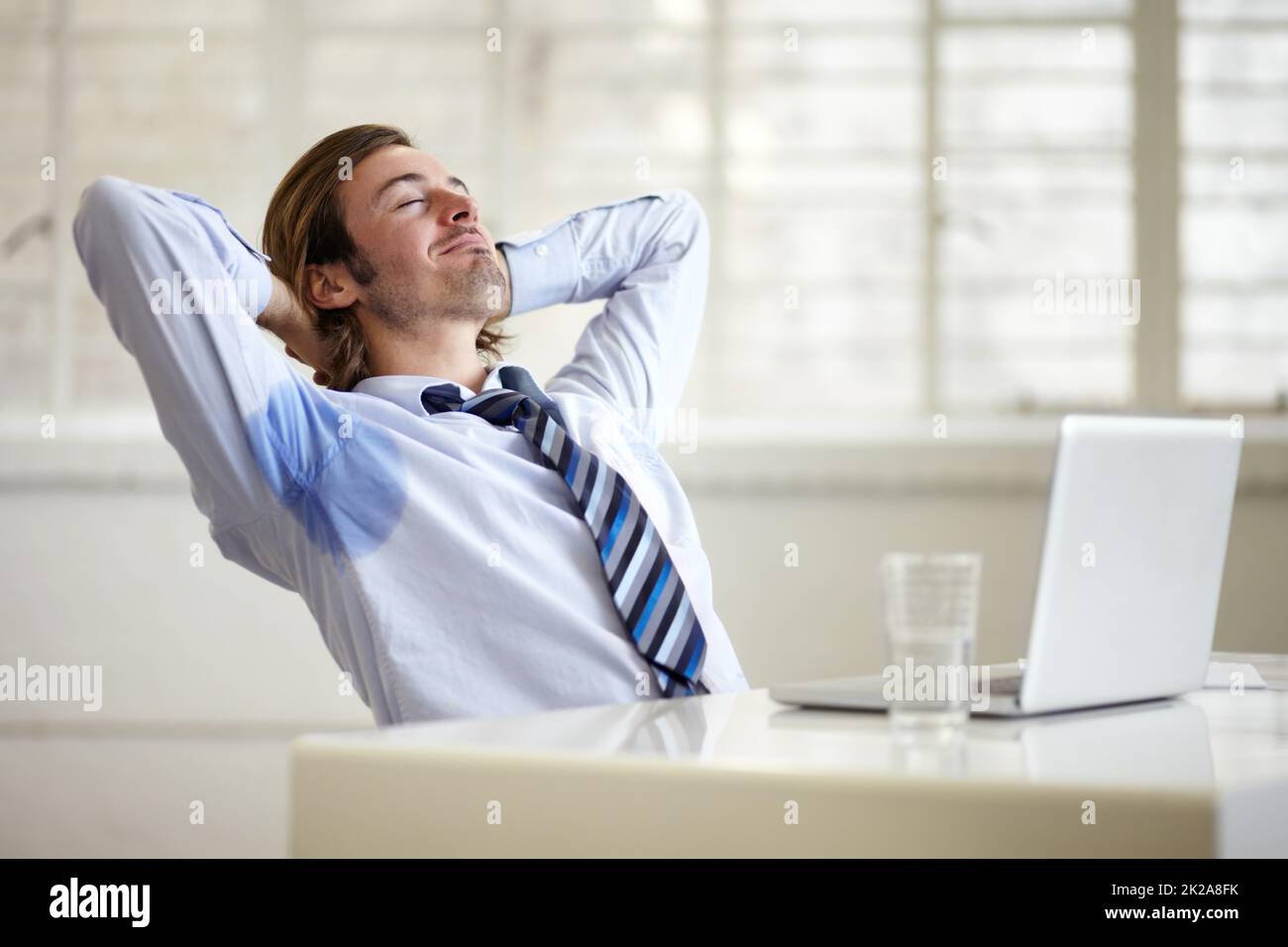 The scent of a true man. A young businessman with sweat stains under