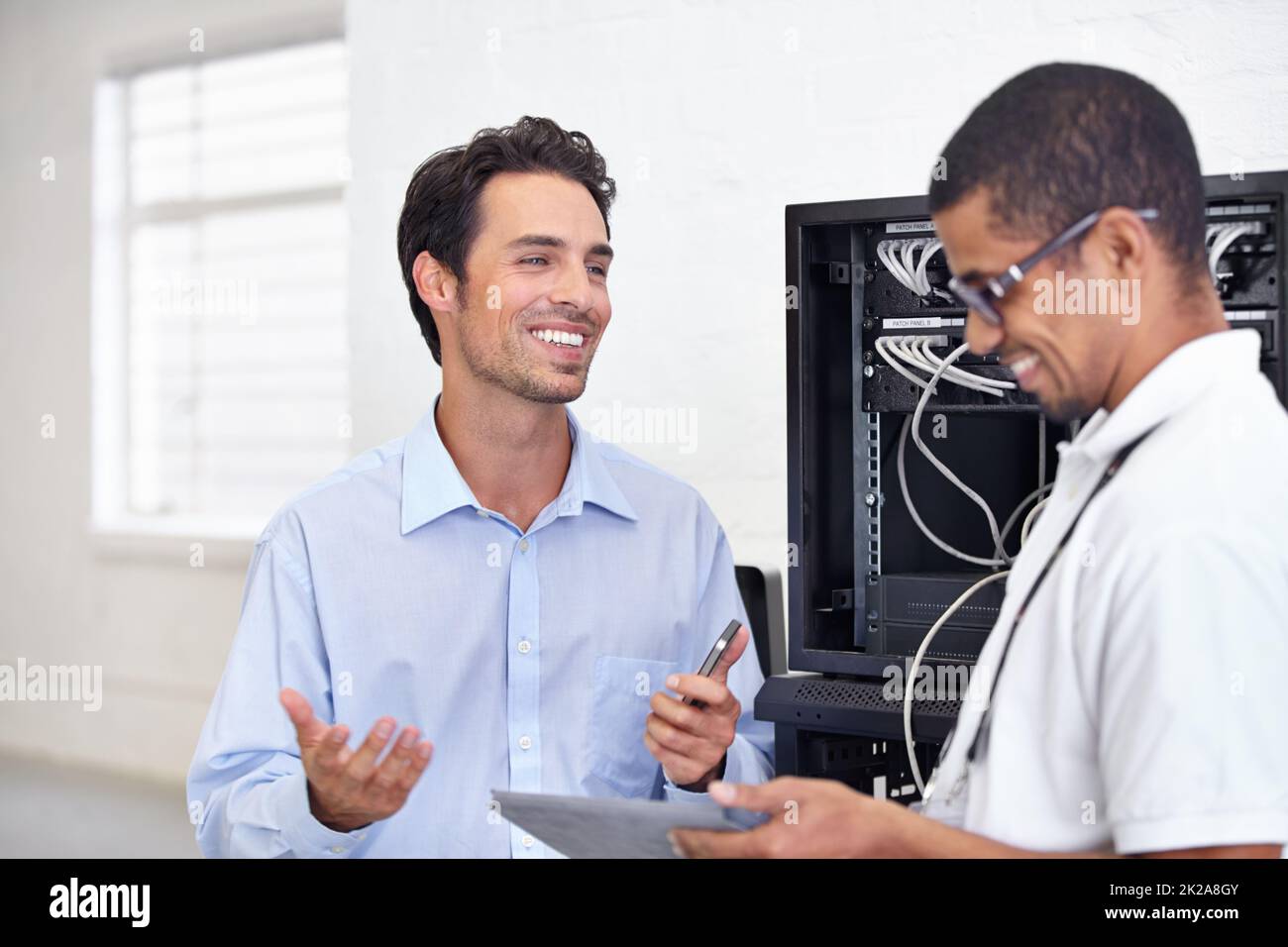 You make IT so simple. A young IT specialist ready to fix a server. Stock Photo