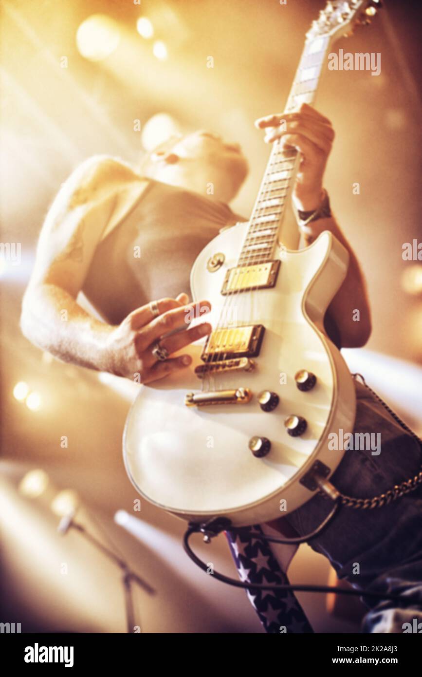 Low angle view of a guitarist on stage at a gig. This concert was