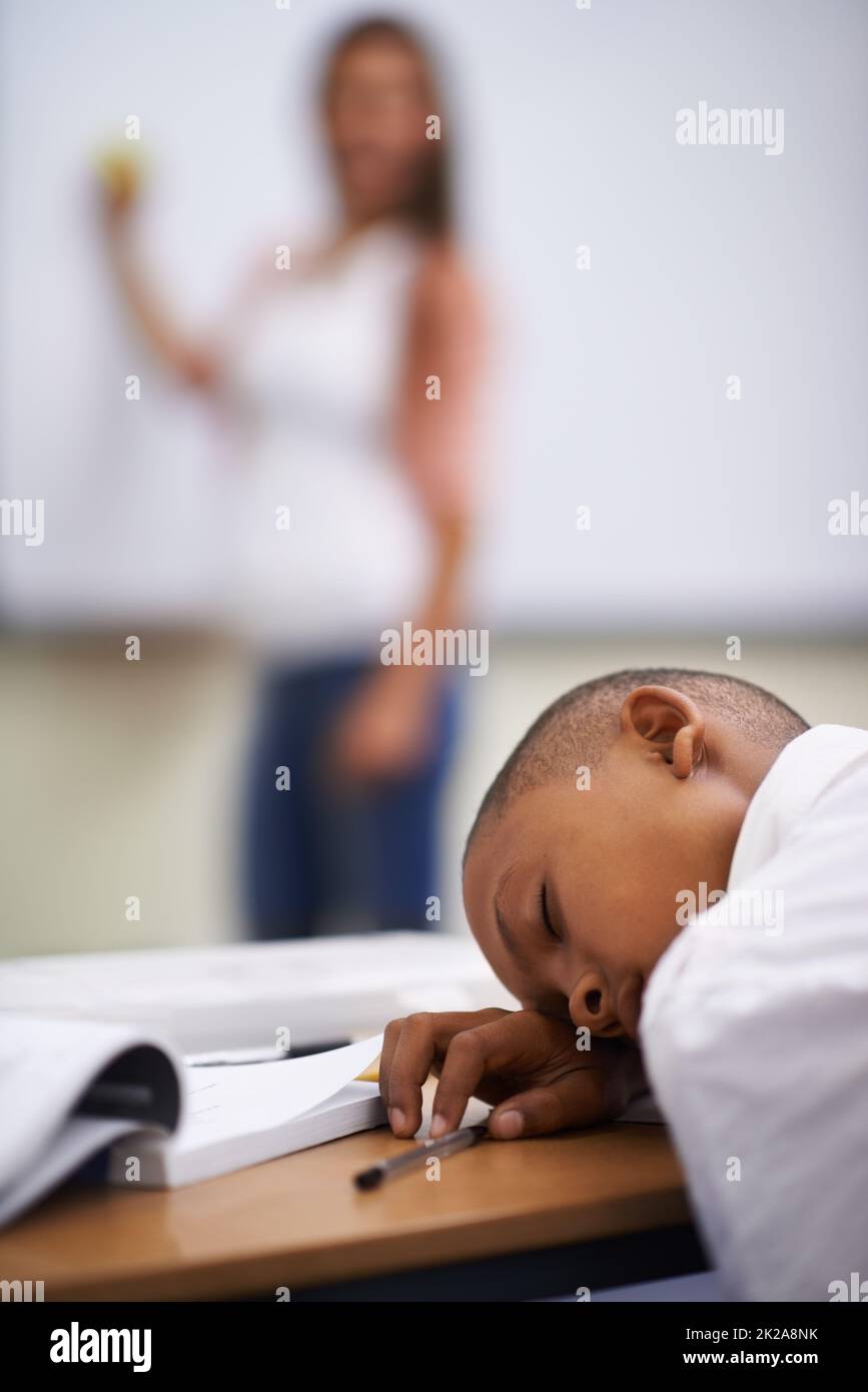 Falling asleep in class. A young boy sleeping in class. Stock Photo