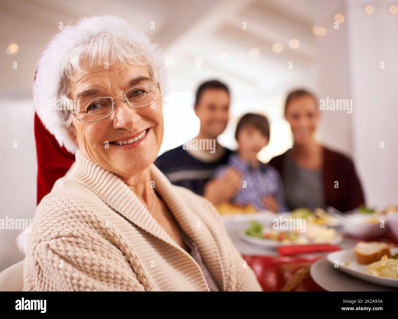 Christmas lunch with the family. A happy family sitting around the dinner table on Christmas day. Stock Photo