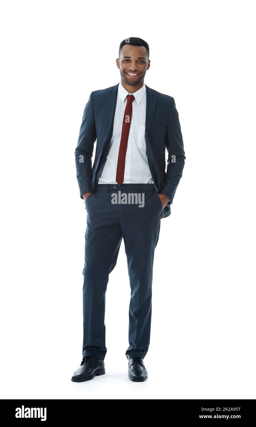 Positivity brings him success. A smiling businessman with his hands in his pockets while isolated on white. Stock Photo