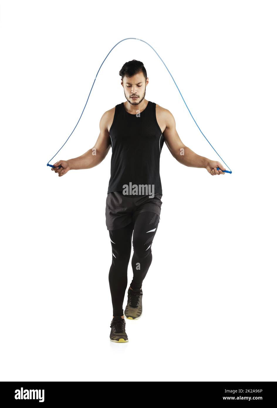 Getting his heart rate going. Studio shot of a young man skipping with a jump rope against a white background. Stock Photo