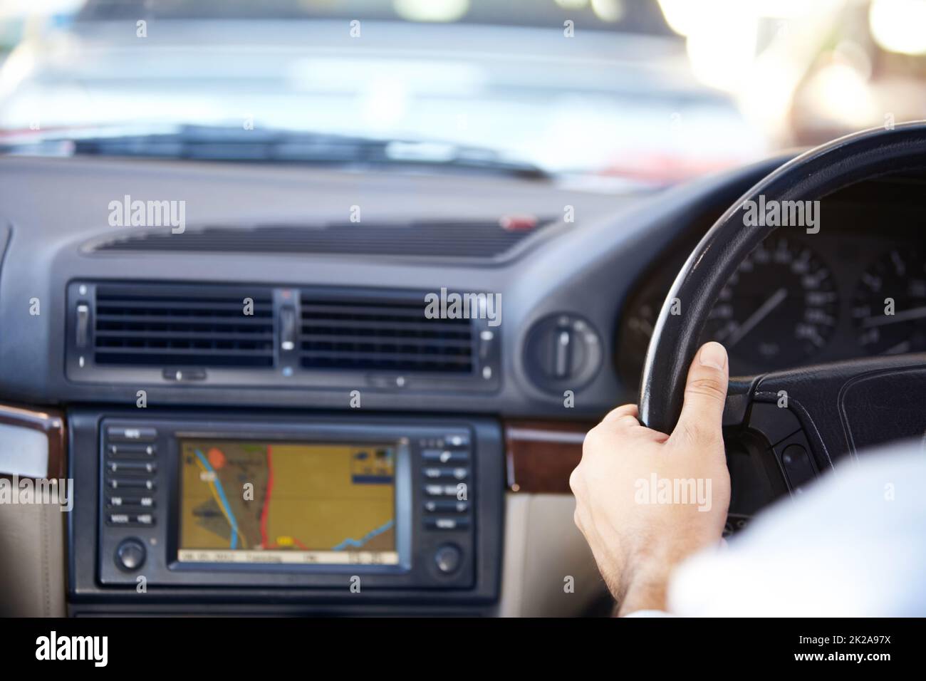 Your destination awaits.... Cropped image of a gps navigation system and a mans hands on the steering wheel of a car. Stock Photo