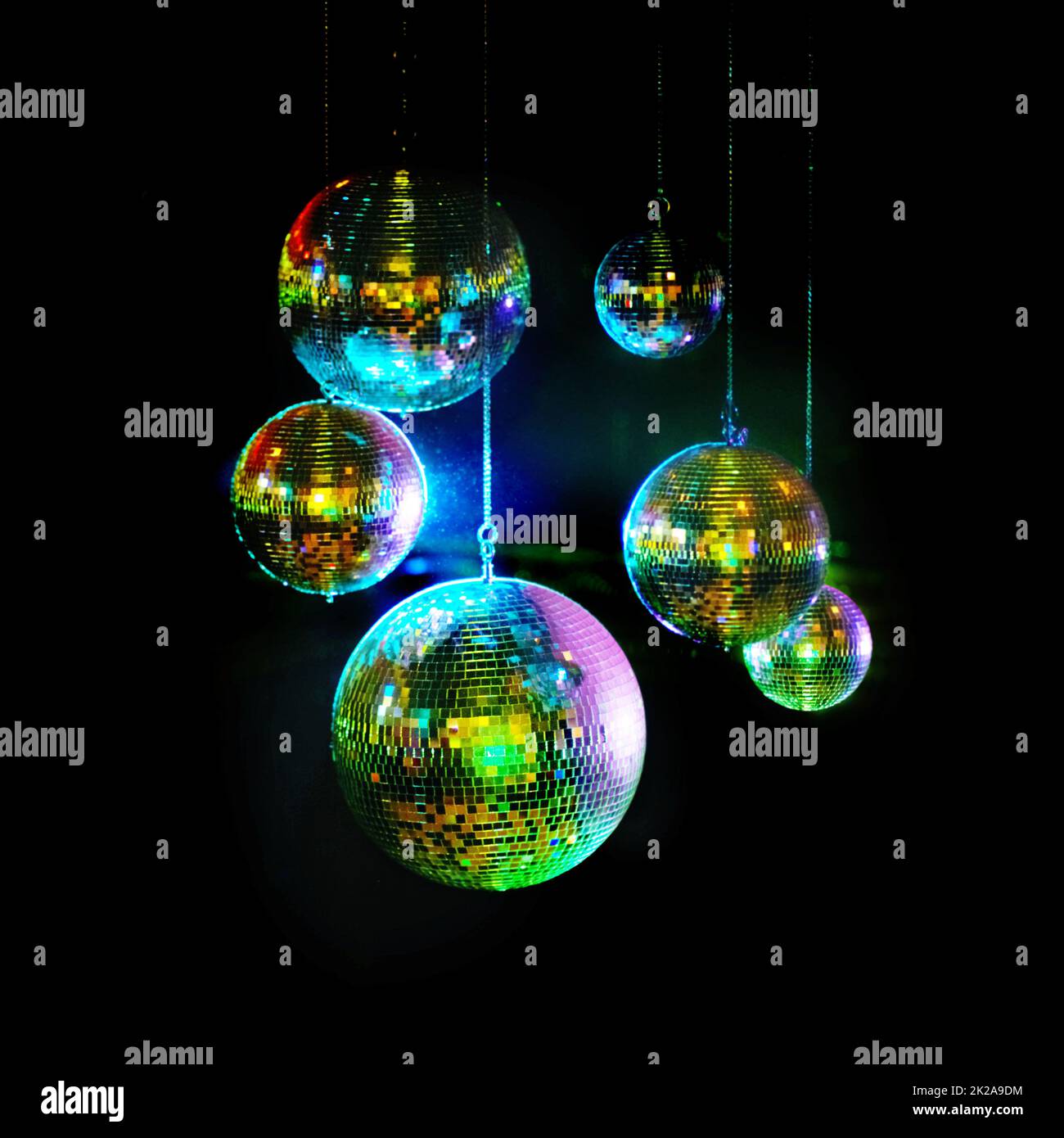 Mirror balls above dance floors. Awesome image of kaleidoscopic-looking disco balls hanging against a black background. Stock Photo