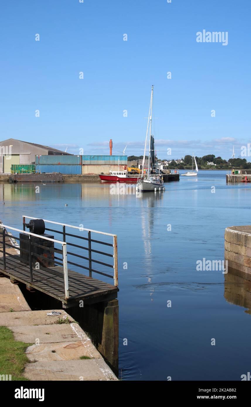 Yacht entering Glasson Dock heading towards the open lock gate on the connection between the Dock and the canal basin September 2022. Stock Photo