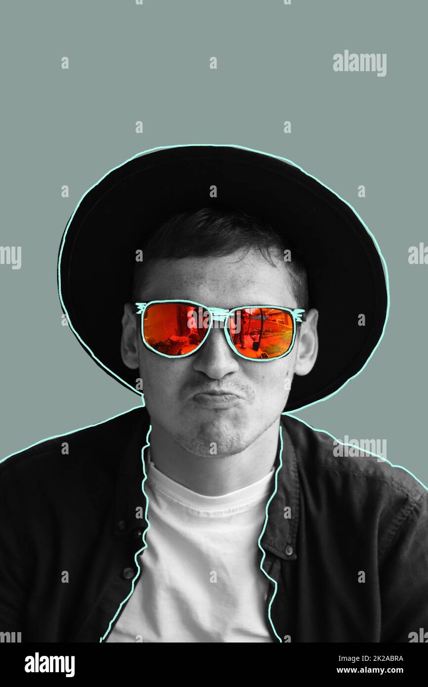 Funny man. Smiling fashion man. Portrait of handsome smiling stylish hipster lambersexual model. Man dressed in red polarization sunglasses and hat. F Stock Photo